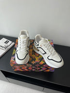 Pair of white Louis Vuitton women’s sneakers with black accents and white laces