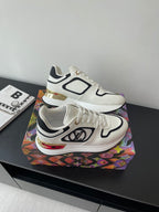 White Louis Vuitton sneakers with black trim and side logo, shown from above