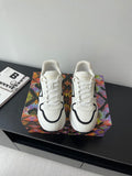 White women’s Louis Vuitton sneakers with black trim and white laces