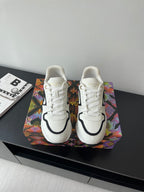White women’s Louis Vuitton sneakers with black trim and white laces