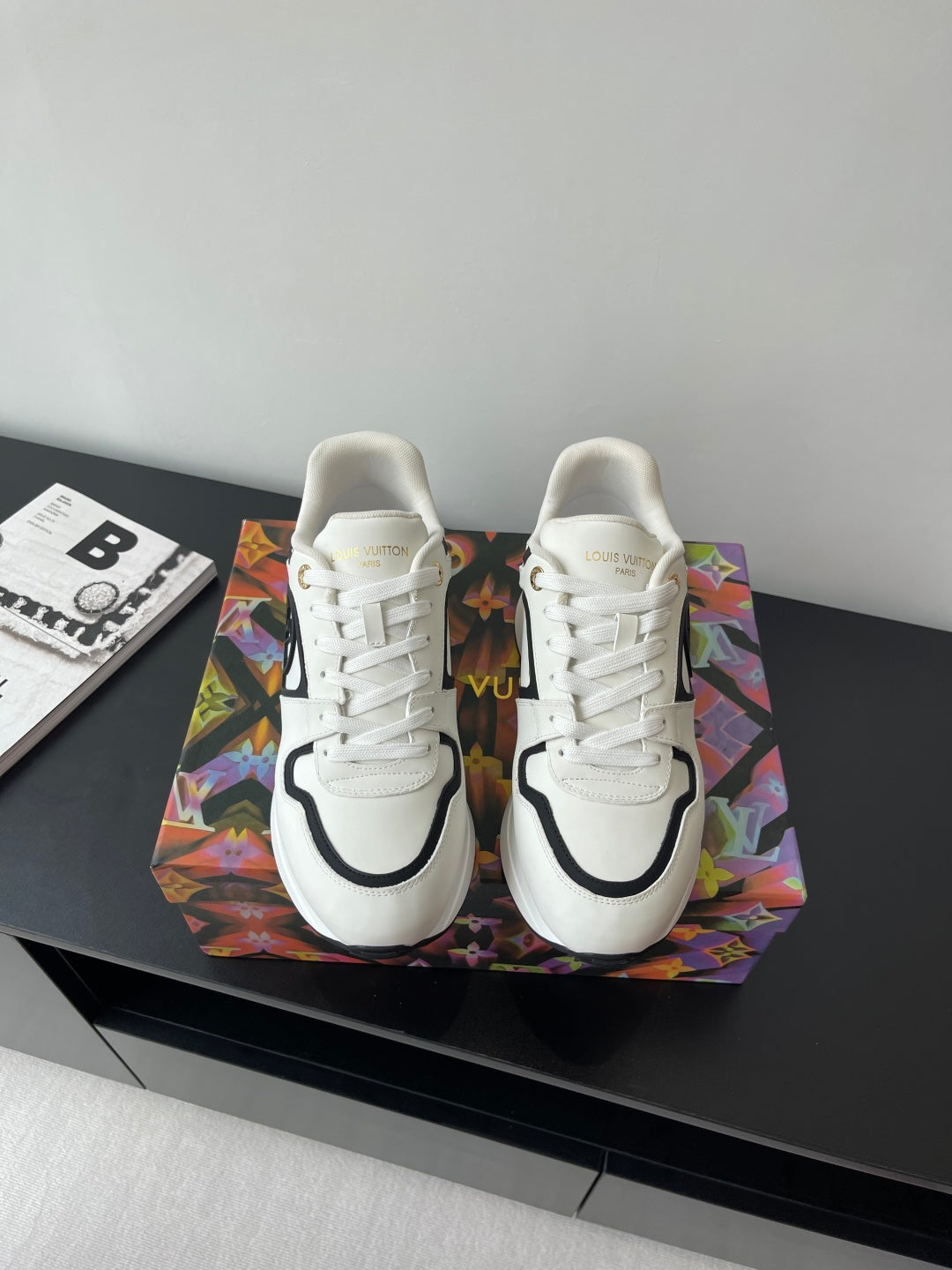 White women’s Louis Vuitton sneakers with black trim and white laces