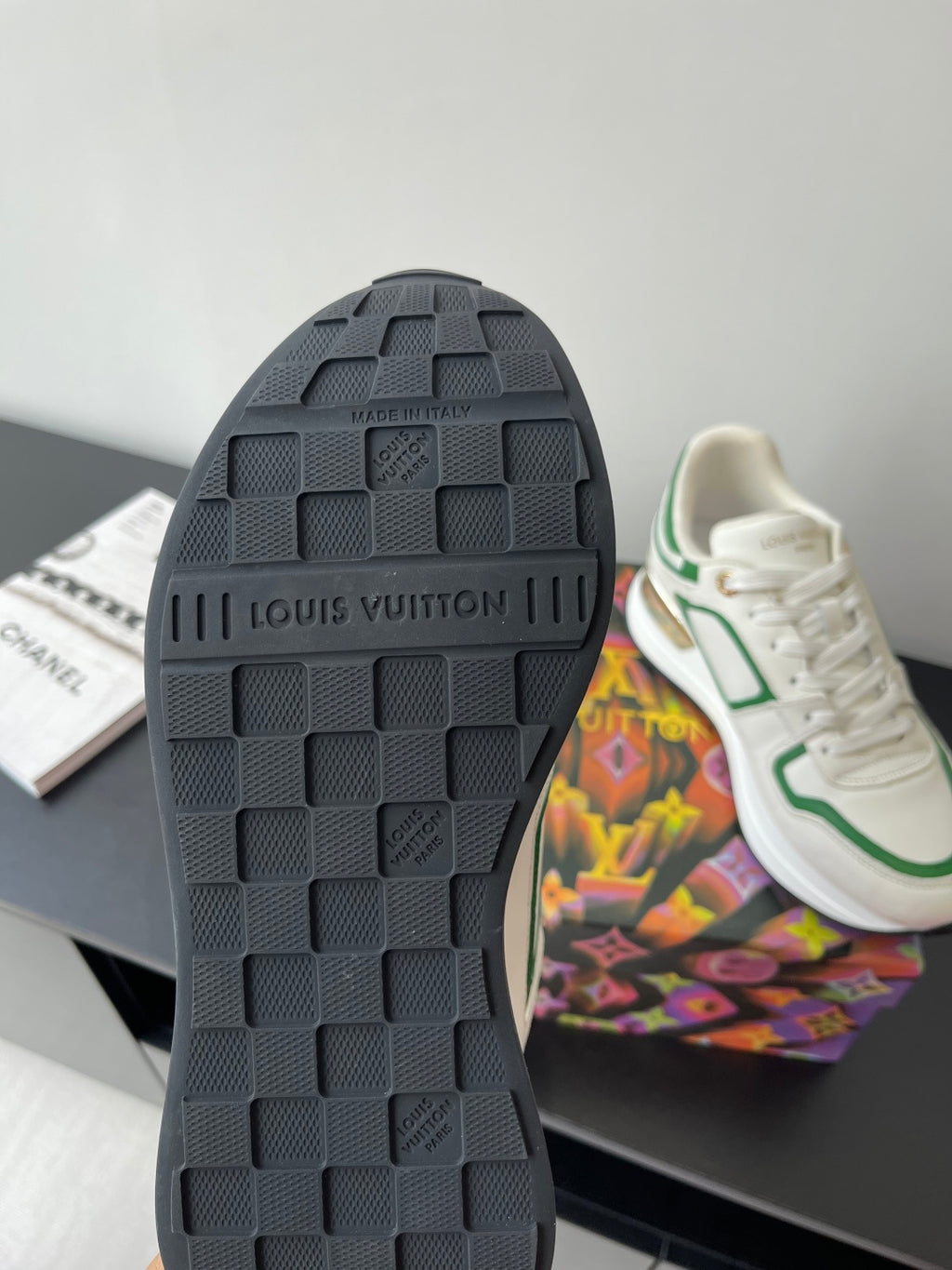 Louis Vuitton women's sneaker outsole, dark tread with embossed brand lettering.