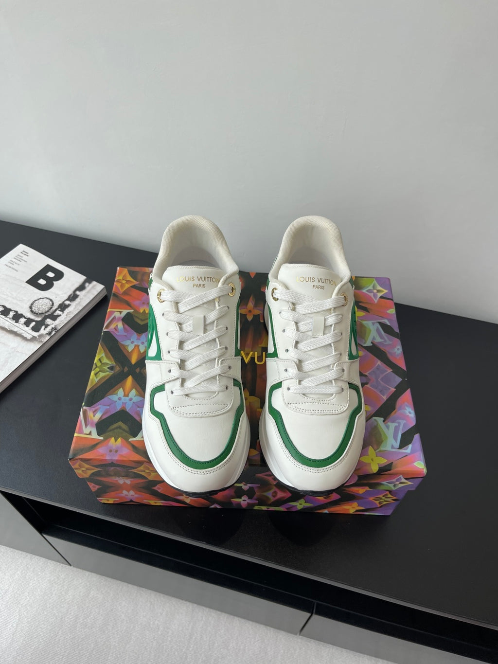 Louis Vuitton women's sneakers, white with green trim and lace-up front.