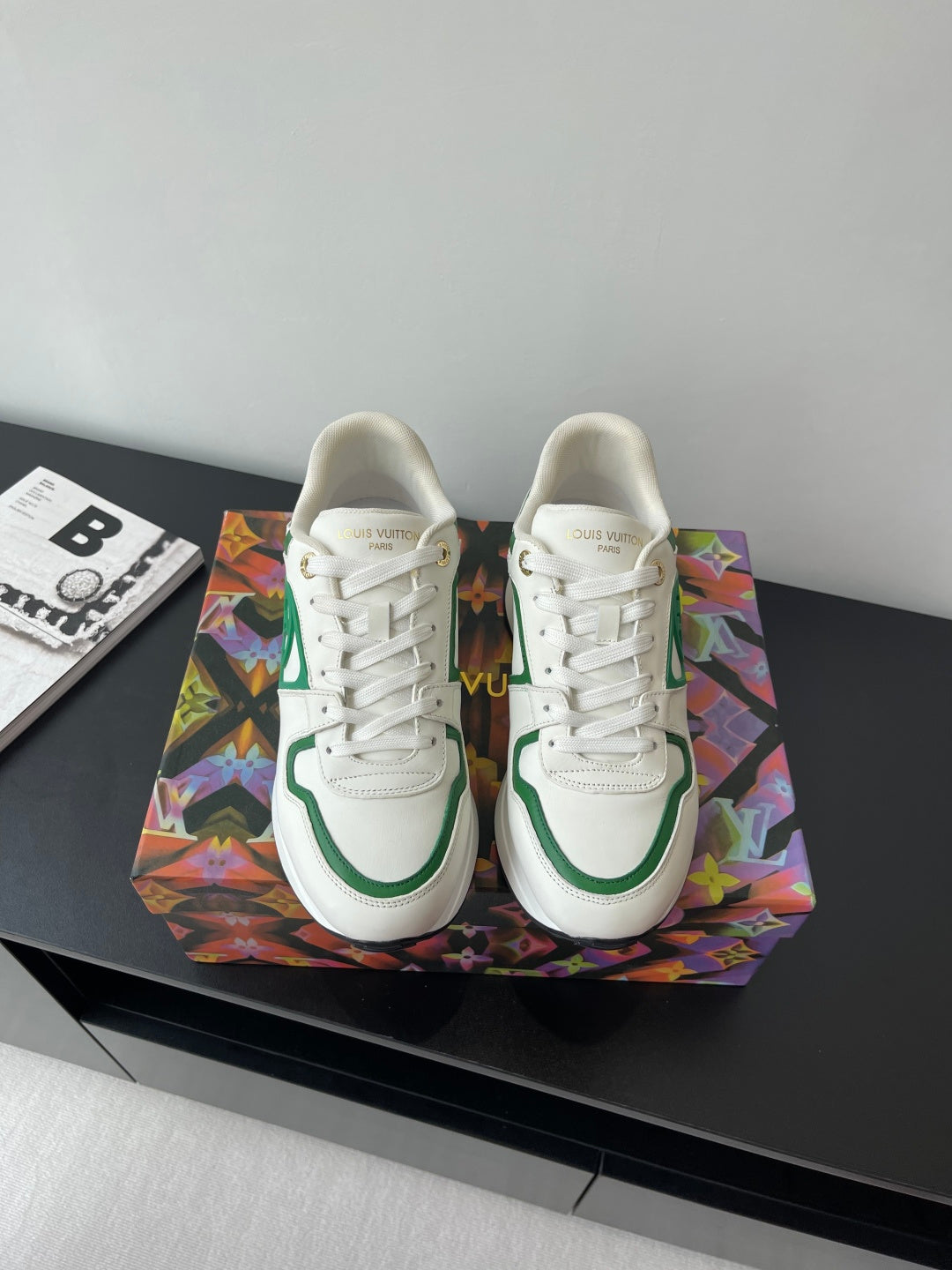 Louis Vuitton women's sneakers, white with green trim and lace-up front.