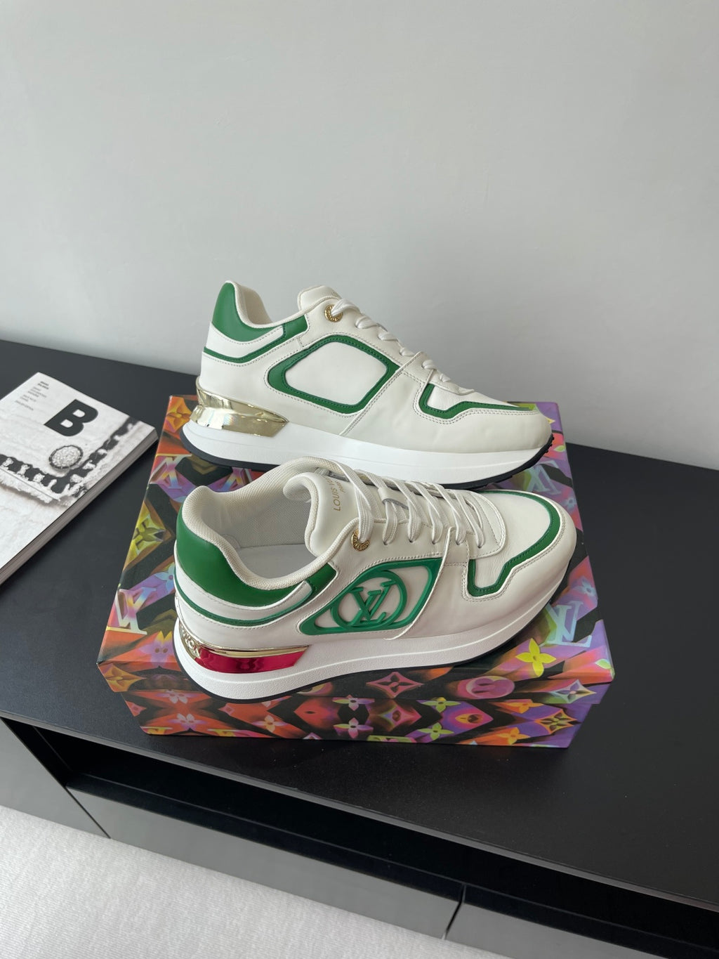 Louis Vuitton women's sneakers top view, white with green panels and low profile sole.