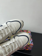 Close-up of white lace-up sneakers with navy-edged collar