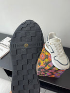 Black treaded sneaker outsole with “Louis Vuitton” logo badge