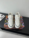 White lace-up sneakers with navy logo and cushioned sole