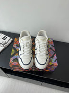White lace-up sneakers with navy logo and cushioned sole
