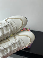 Louis Vuitton white sneakers, close-up of lace panel and rounded toe