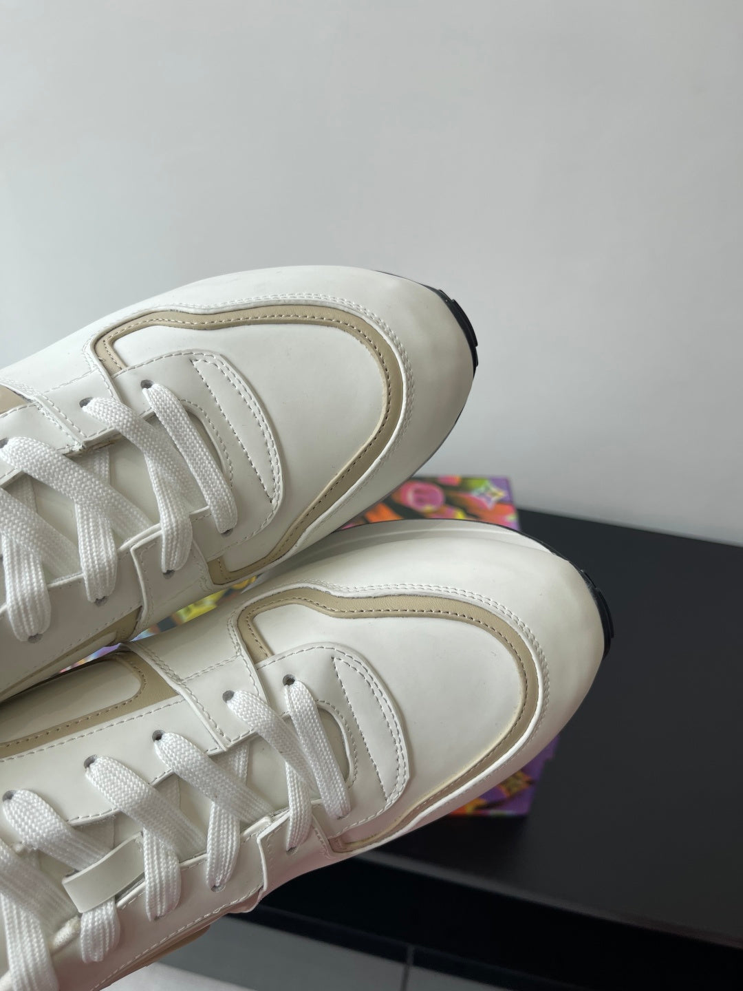 Louis Vuitton white sneakers, close-up of lace panel and rounded toe