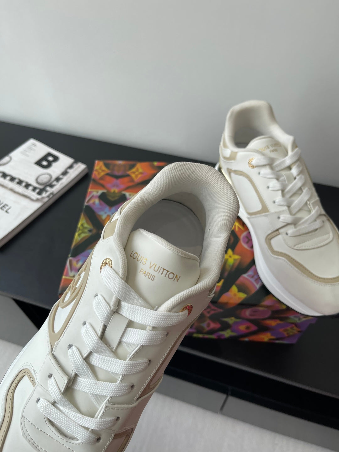 Louis Vuitton white lace-up sneaker with gold logo detail and padded collar