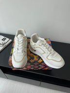 Pair of Louis Vuitton white lace-up sneakers, side and toe view