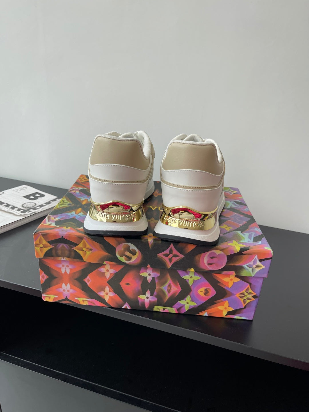 Louis Vuitton white sneakers, rear view with padded heel and gold stripe