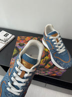 Louis Vuitton ladies sneakers, close-up of blue uppers with white laces and tan detail.