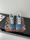 Louis Vuitton ladies sneakers, blue denim with white laces and tan-trim accents.