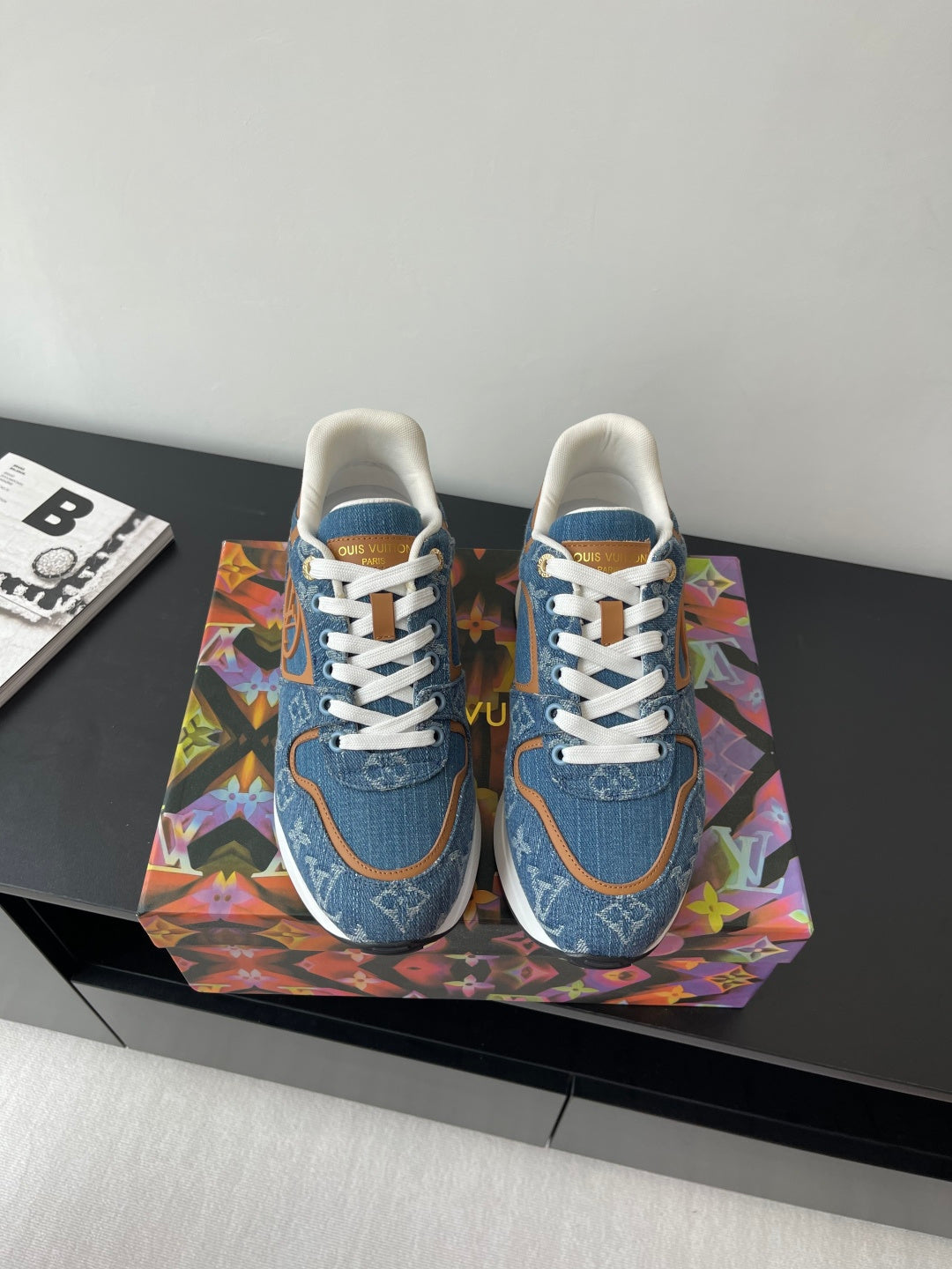 Louis Vuitton ladies sneakers, blue denim with white laces and tan-trim accents.