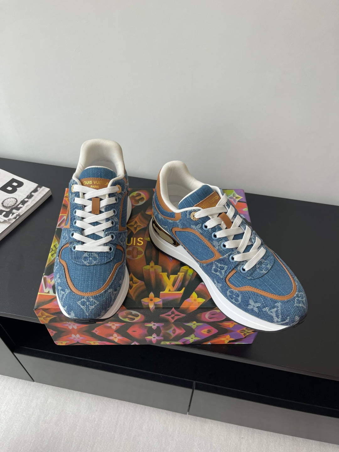 Louis Vuitton ladies sneakers, blue denim with white laces and tan trim on sides.