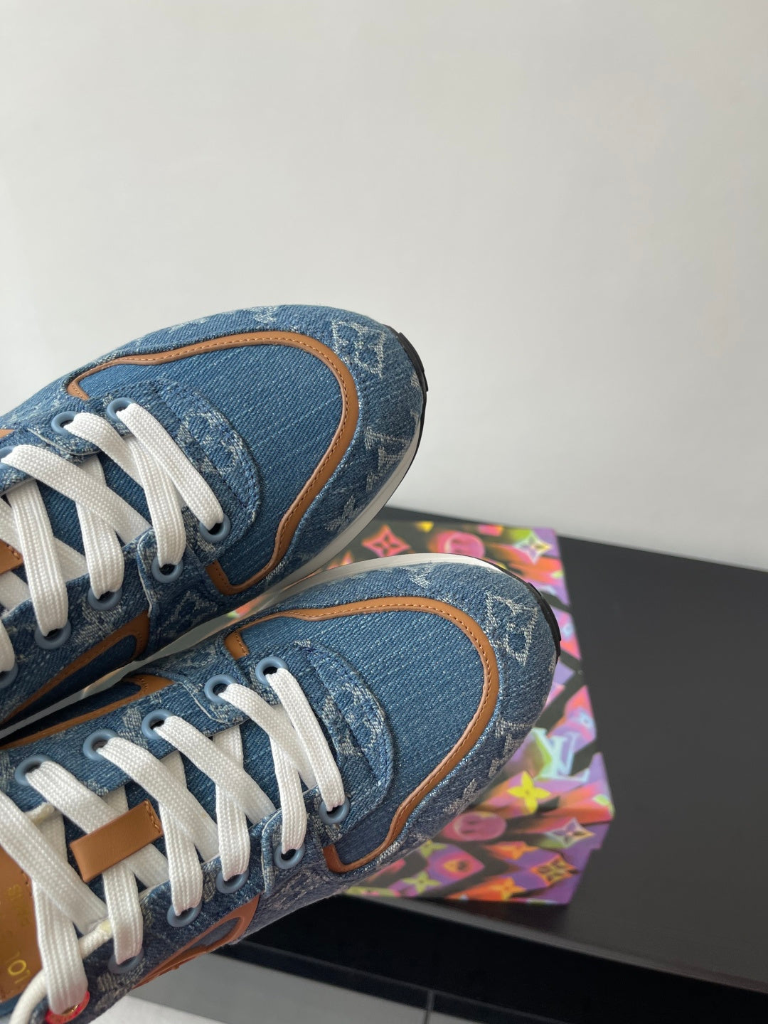 Louis Vuitton ladies sneakers heel and toe view, blue denim texture with white laces.