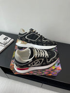 Women’s low-top sneakers, black monogram, white laces, gold-accent midsole