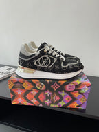 Women’s low-top sneakers, black monogram print, white laces, gold heel trim