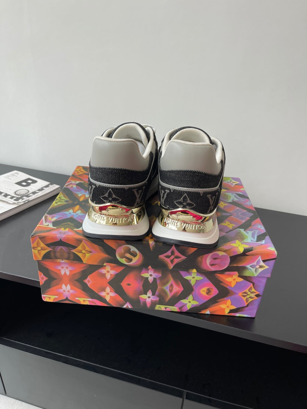 Women’s low-top sneakers, rear view, black monogram, cream heel tabs, white laces