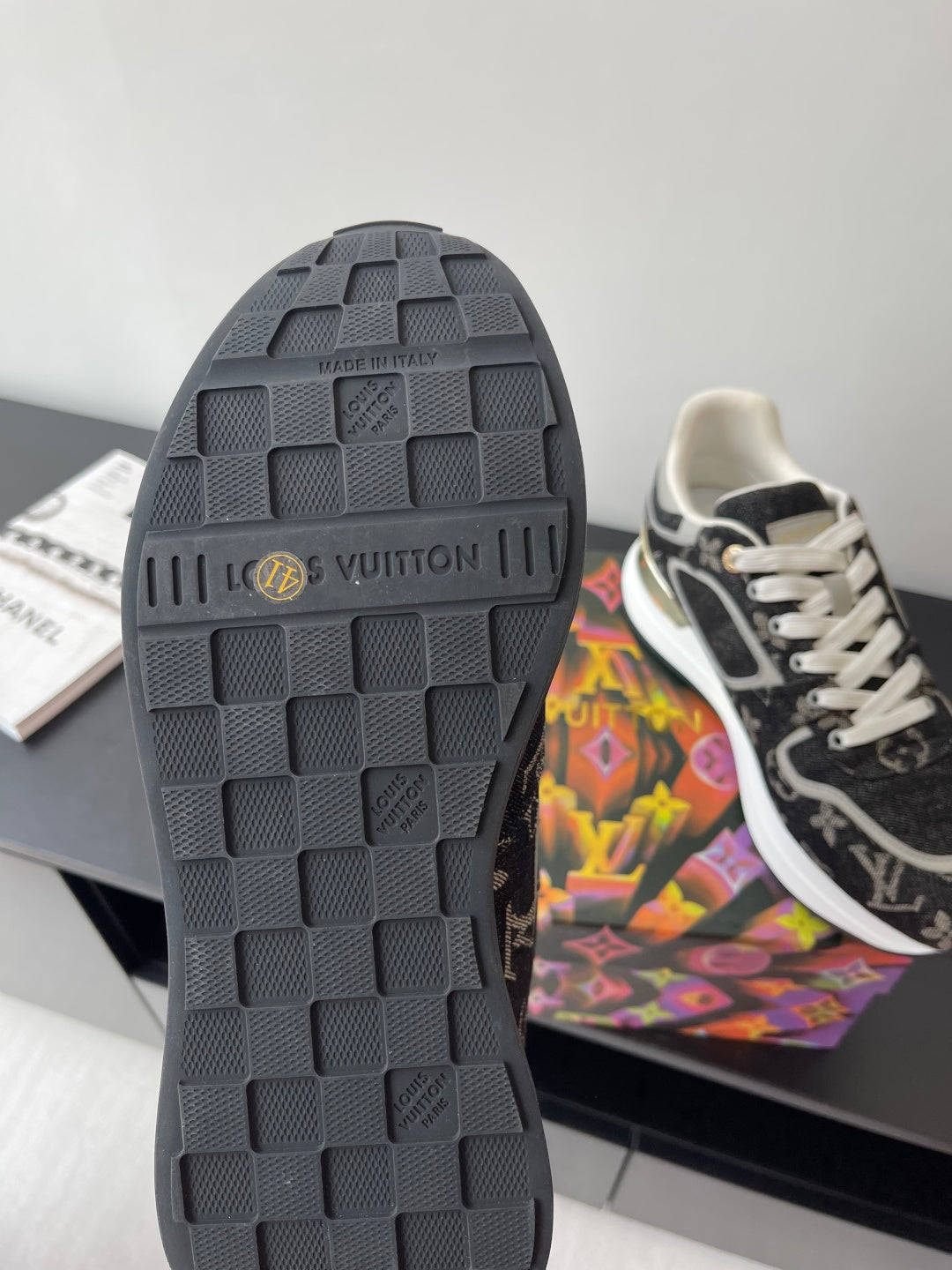 Sneaker outsole, dark rubber tread with Louis Vuitton logo and grip pattern