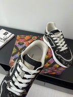Women’s low-top sneakers close-up, cream lining, black monogram panels, white laces