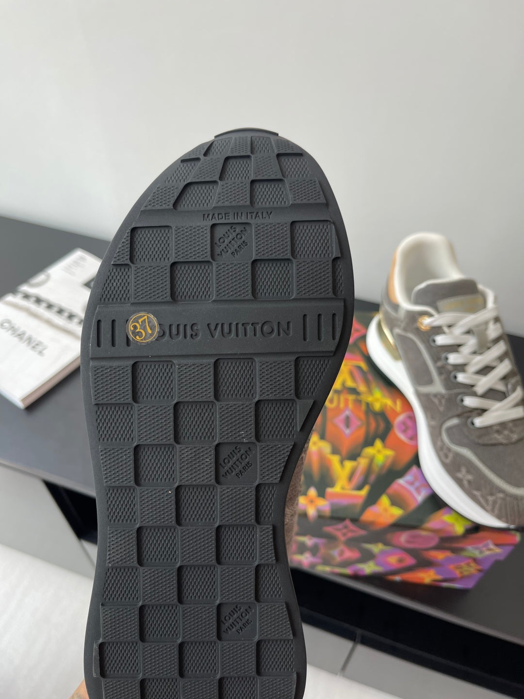 Black rubber outsole with rectangular tread and embossed brand markings