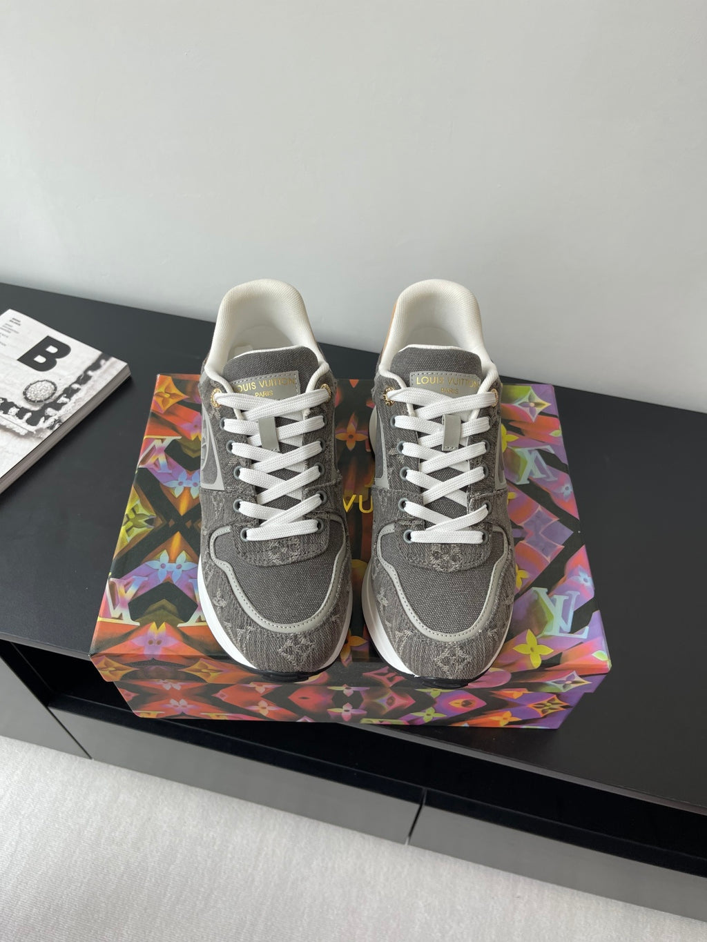 Gray low-top lace-up sneakers with patterned panels and white stripe accents