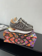 Gray patterned lace-up sneakers with white laces and gold-toned heel detail