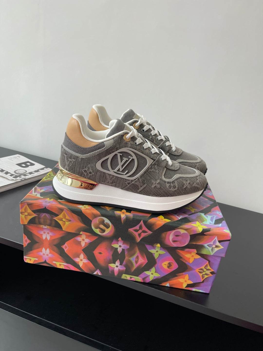 Gray patterned lace-up sneakers with white laces and gold-toned heel detail