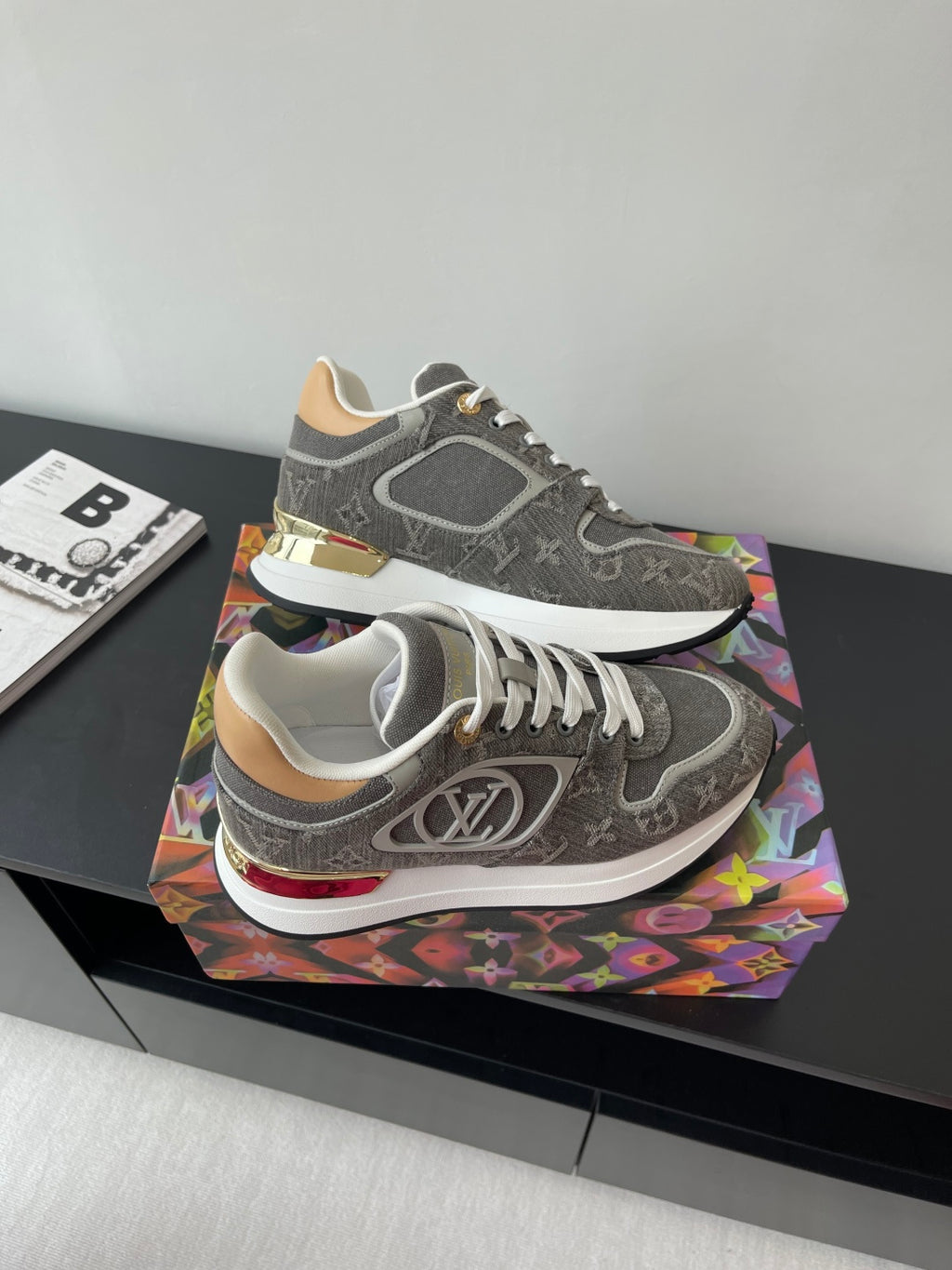 Gray and white lace-up sneakers with patterned upper, stacked midsole details