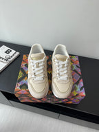 Women's cream lace-up sneakers with gold LV logo on side