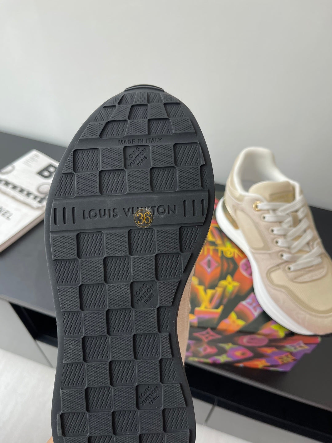 Women's sneaker outsole with black tread and 'Louis Vuitton' stamp
