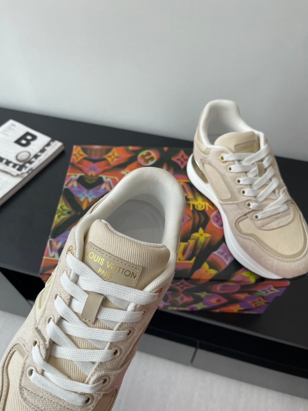 Women's cream lace-up sneakers with 'Louis Vuitton' label on tongue