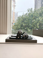 Black studded slide sandals with straps and silver buckles, open toe