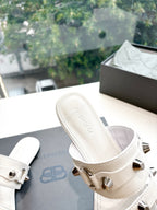 White Balenciaga mule slide sandal with metal buckle strap and embossed footbed