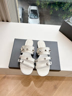 White Balenciaga slide sandals with two strap buckles and stacked strap design
