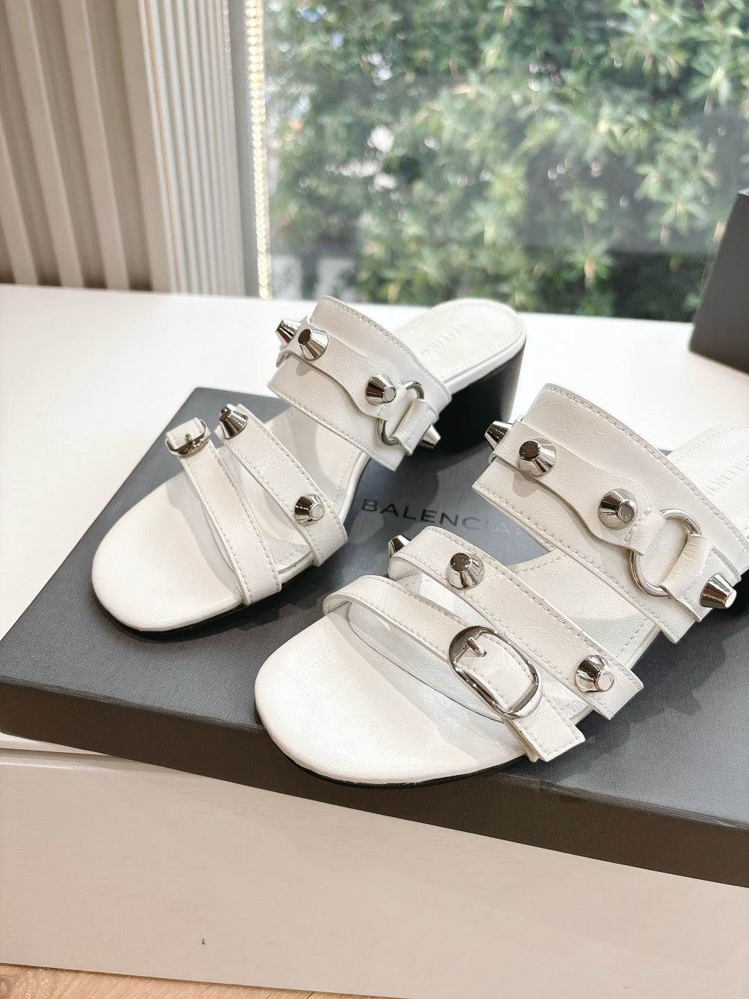 Balenciaga women's white slide sandals with metal buckles on multiple straps
