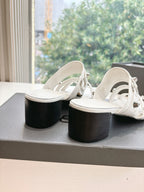 Balenciaga women's white slide sandals with black block heels and buckled straps