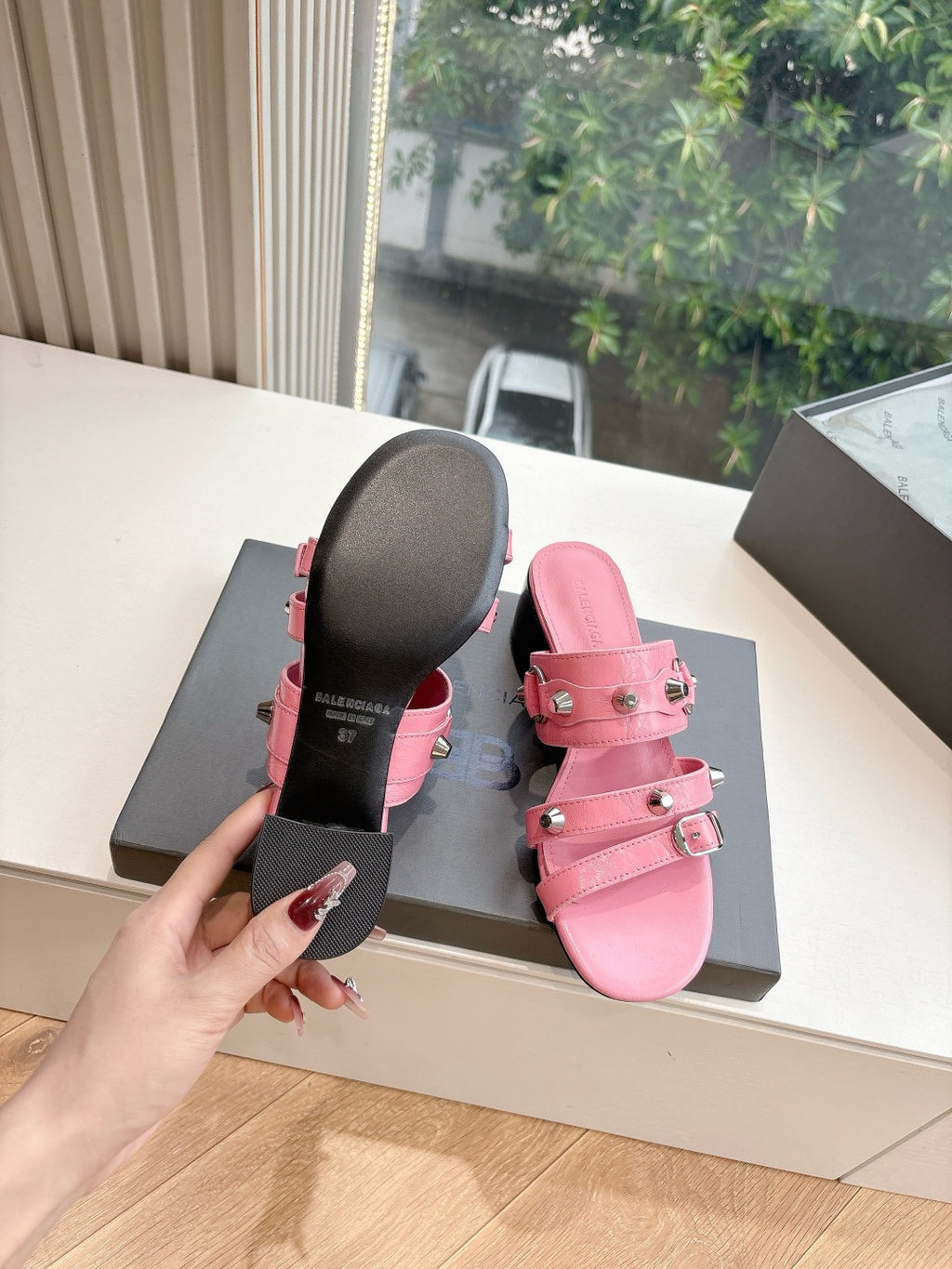 Pink slide sandals with rubber sole base and metal buckle hardware