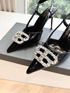 Women's black patent slingback heels with silver jeweled square buckle, close-up