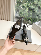 Women's black patent slingback heels with silver jeweled square buckle and hangtag