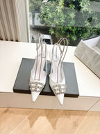 Women's white slingback heels, front view with silver jeweled buckle detail