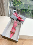 Pink slingback pumps with pointed toe, stiletto heel, ankle strap and gold buckle