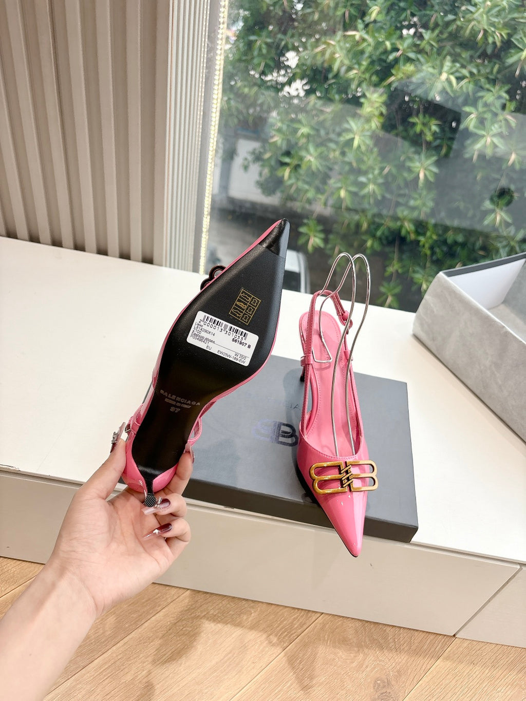 Pink slingback heels showing inside sole and box, gold buckle ankle strap