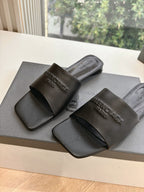 Balenciaga black slide sandals with molded footbed and embossed logo straps