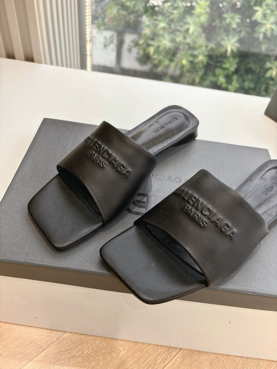 Balenciaga black slide sandals with molded footbed and embossed logo straps
