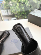 Balenciaga black slide sandal upper with embossed logo detail